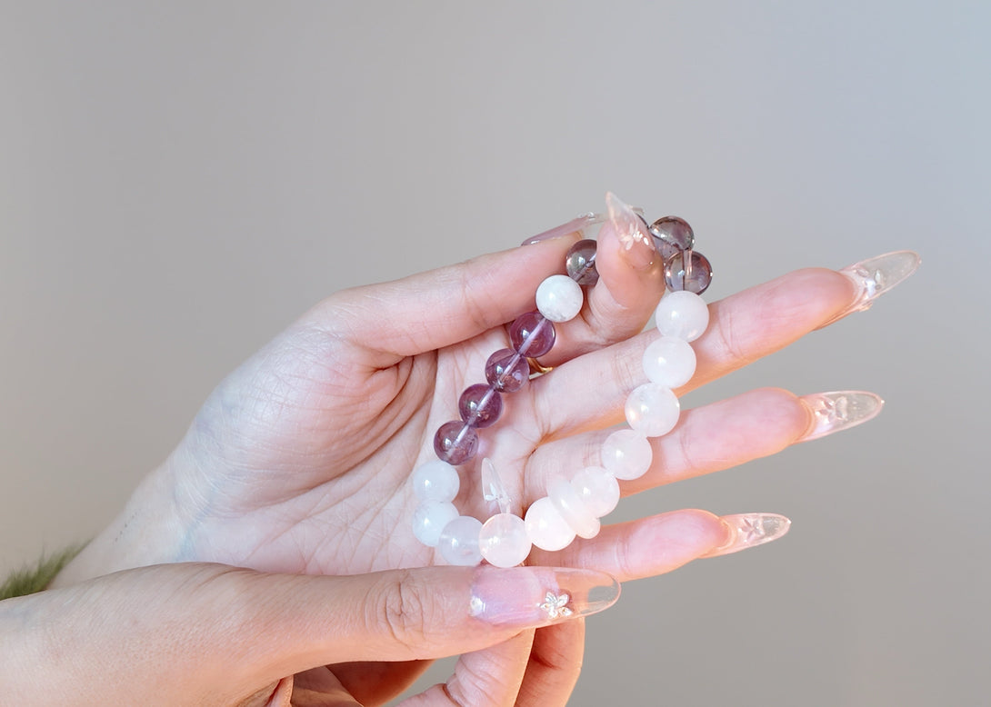 Model holding Amethyst and Phantom Quartz spiritual clarity bracelet